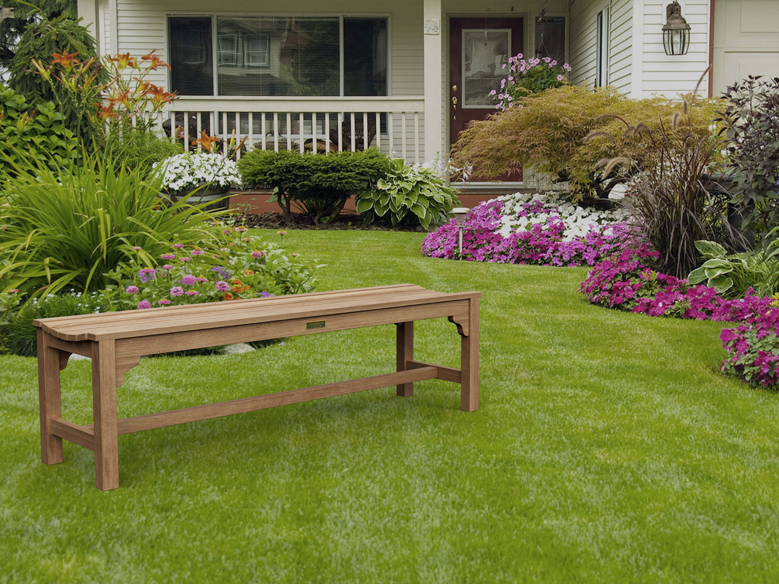 Wooden bench on a well-maintained lawn with flowers and a house in the background