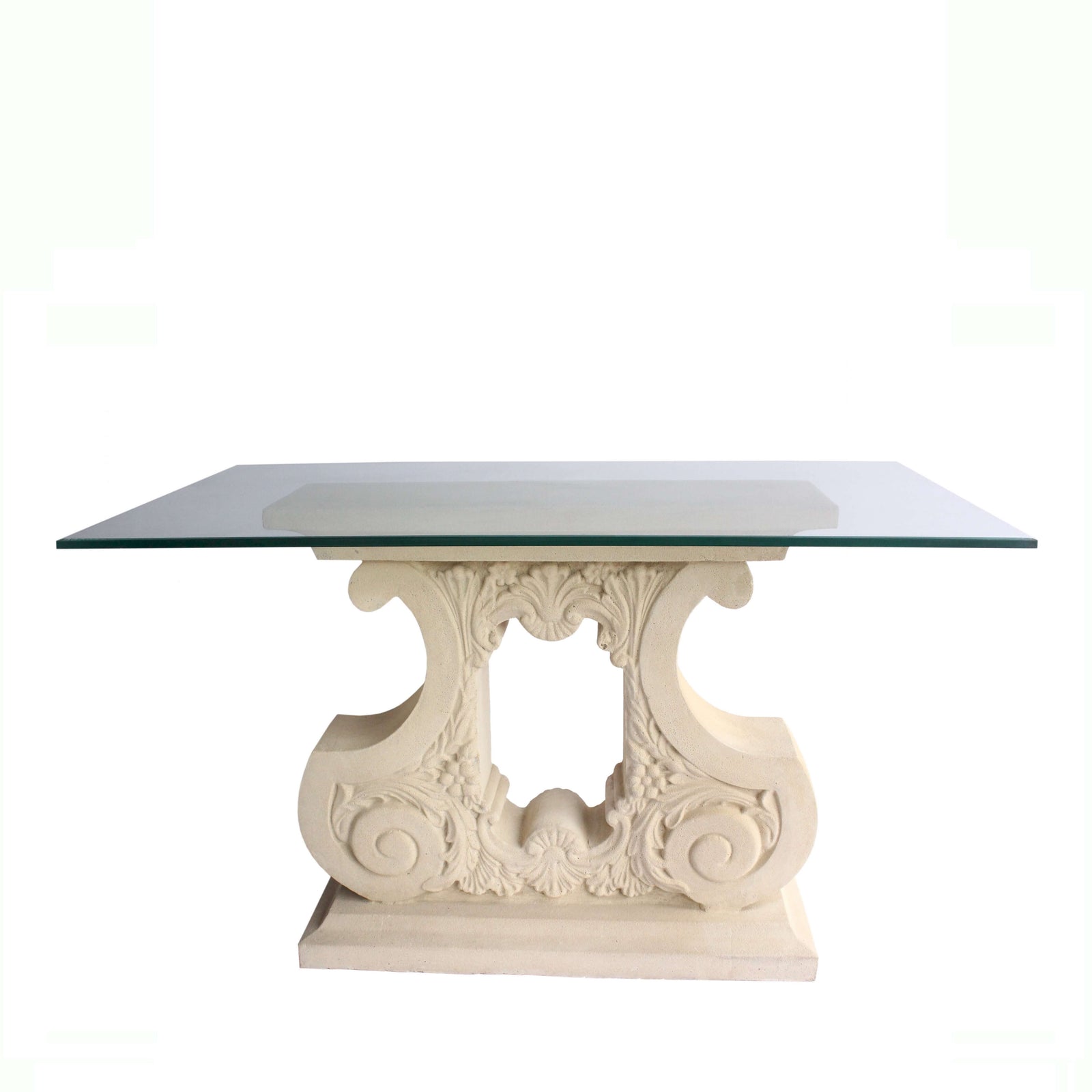 Decorative table with glass top and intricate white base on a white background