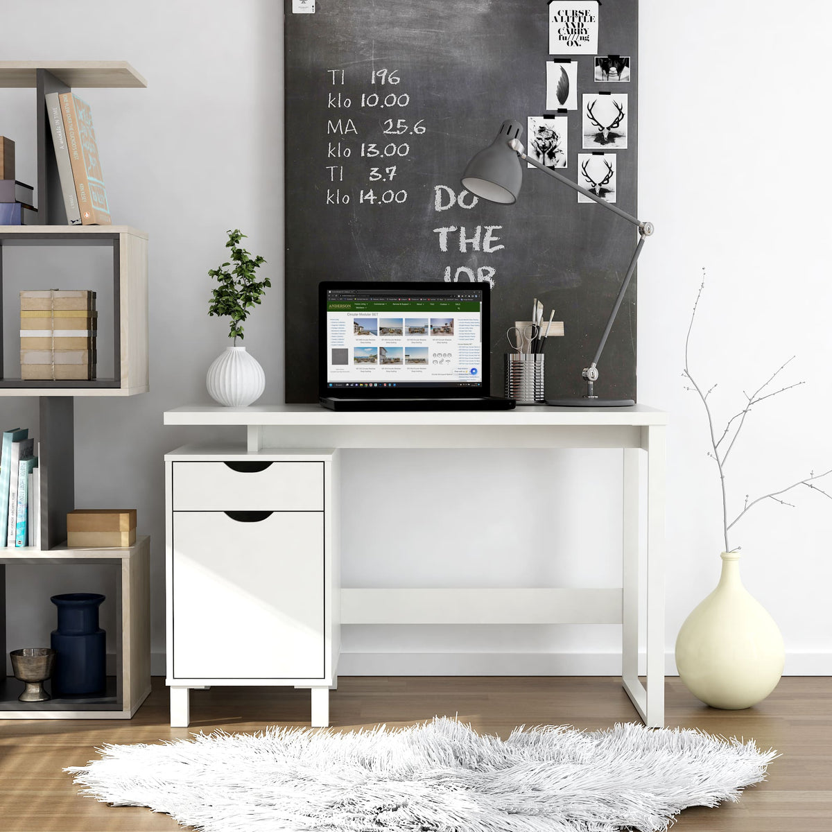 Modern home office with a desk, computer, and chalkboard wall.