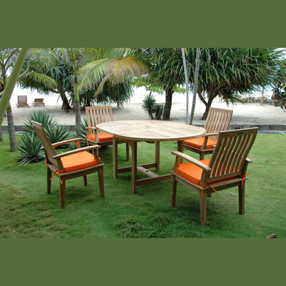 Outdoor wooden table with four matching chairs on a grassy area with palm trees in the background.