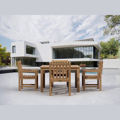 Wooden outdoor dining set with modern building and pool in the background