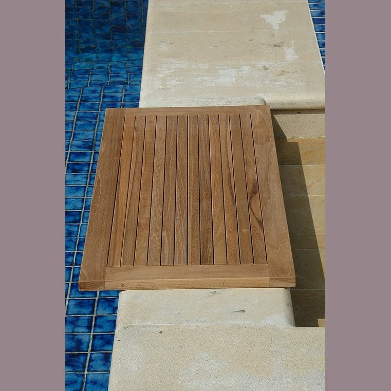 Wooden step on a pool deck with blue tiles