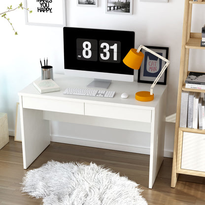 White desk with computer setup in a room with a bookshelf and decorative items.