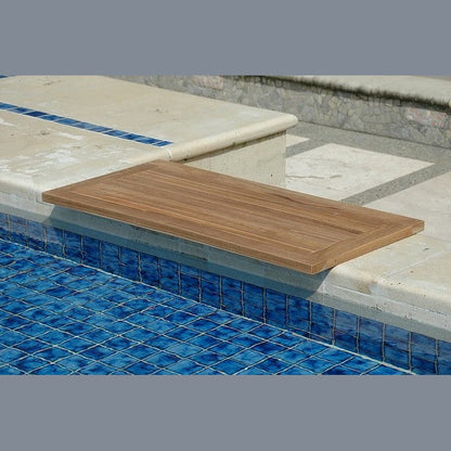 Wooden diving board on a pool deck with blue tiles