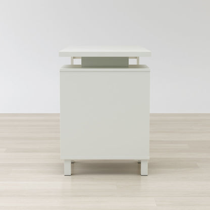 White nightstand with a green accent on a wooden floor and white wall background