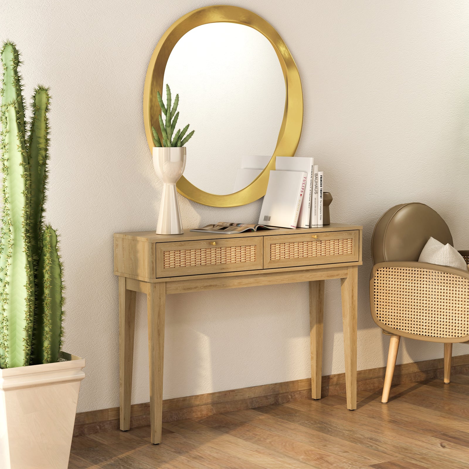 Wooden console table with gold-framed mirror, books, and a plant in a room with wooden flooring.