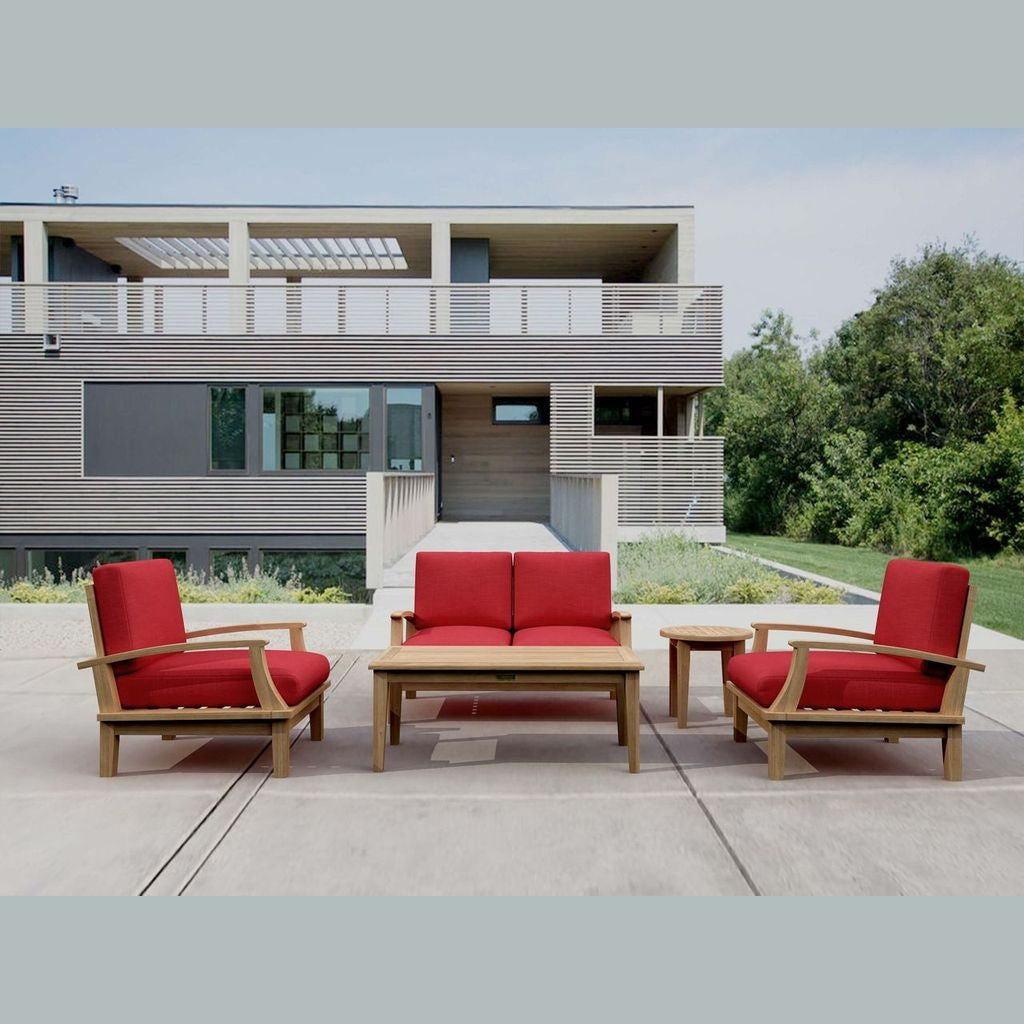 Red outdoor furniture set with wooden table on a patio