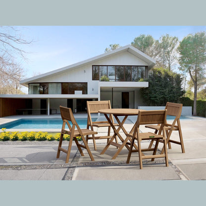 Wooden outdoor dining set in front of a modern house with a pool.