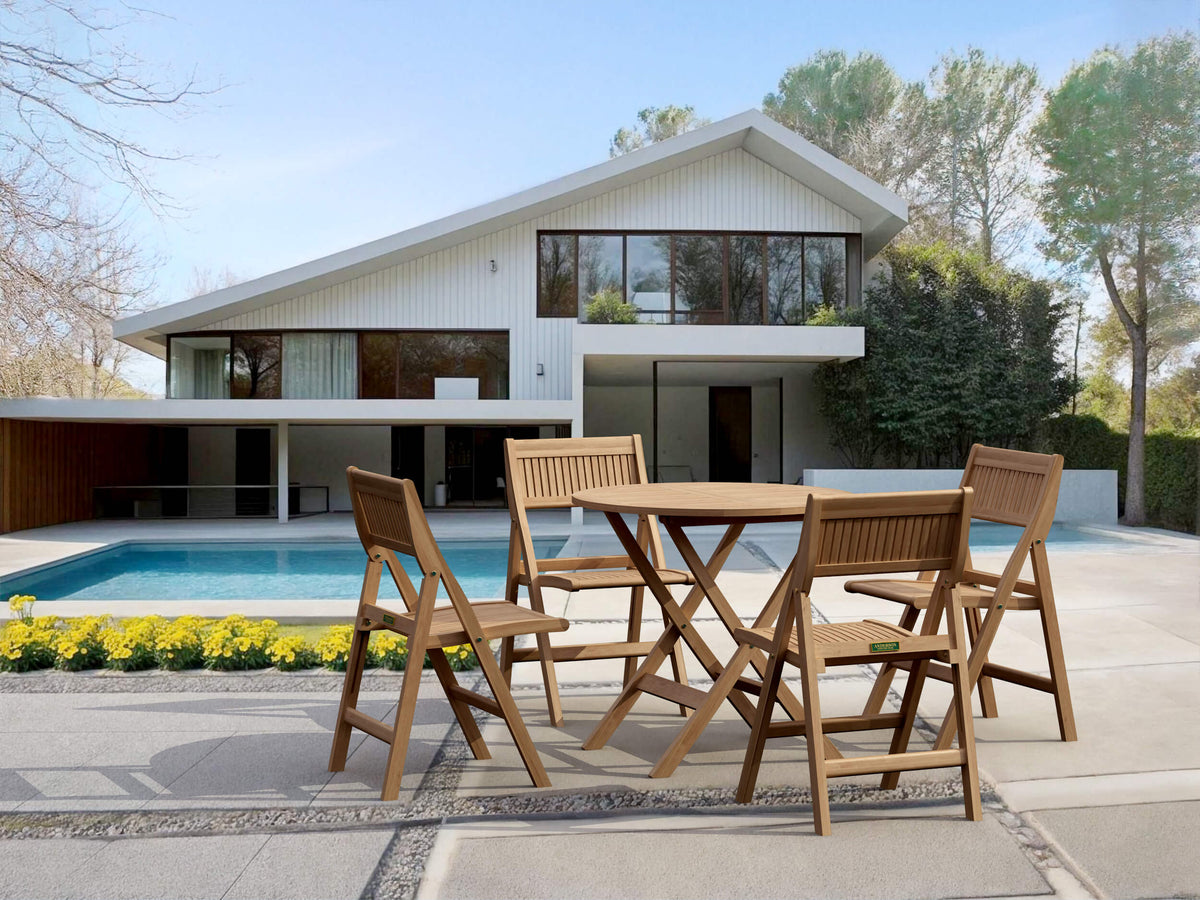 Wooden outdoor dining set in front of a modern house with a pool.