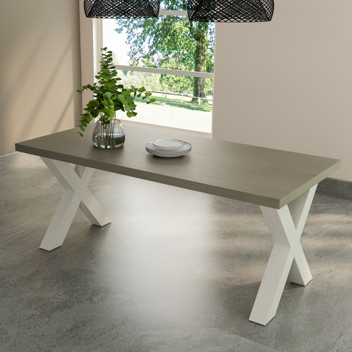 Dining table with white legs and gray top in a room with a window and plants.