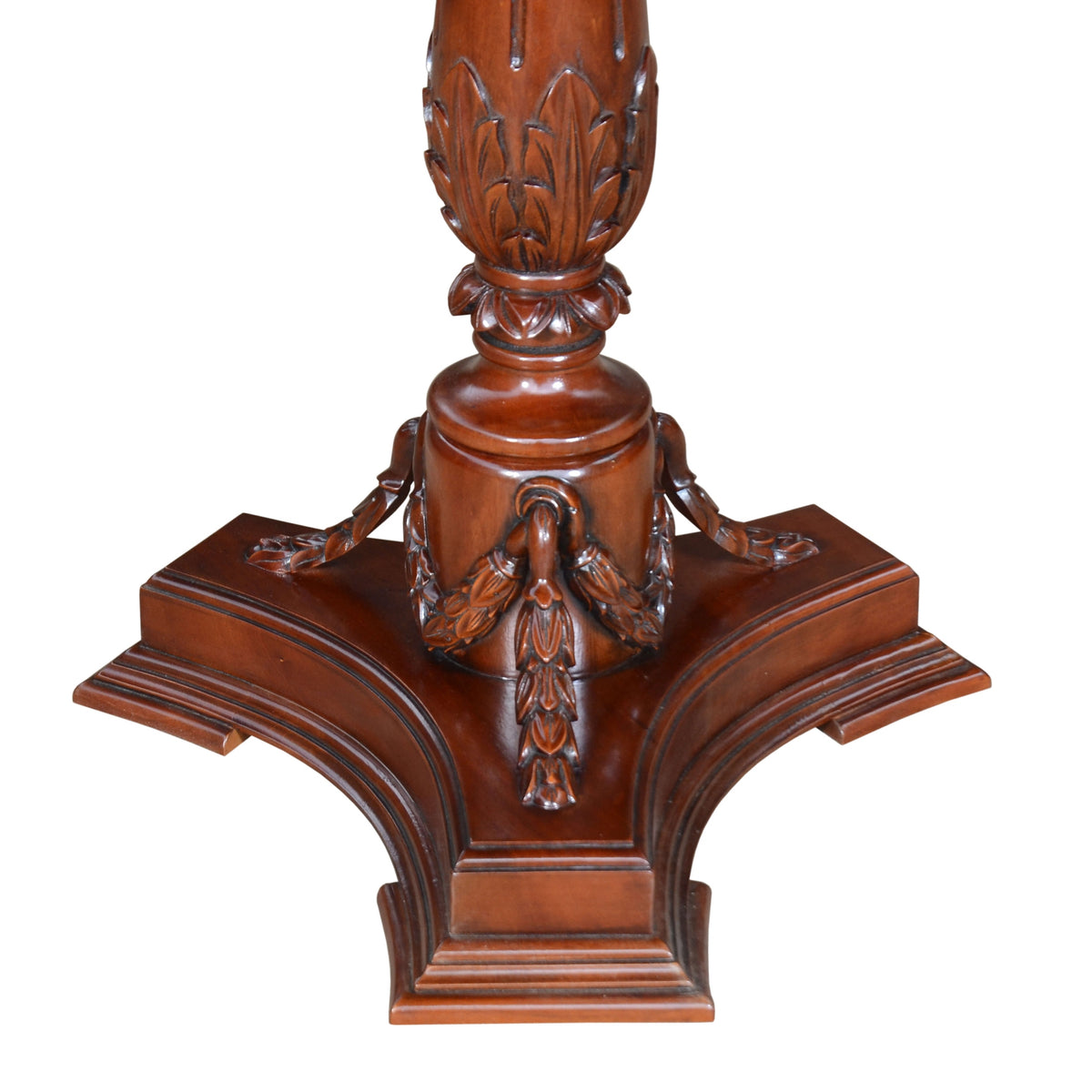 Decorative wooden pedestal with intricate carvings on a white background