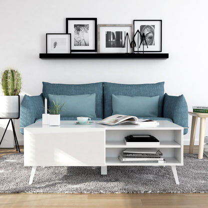 Modern living room with blue sofa, white coffee table, and decorative items.