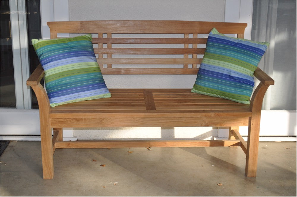 Wooden bench with striped cushions on a patio