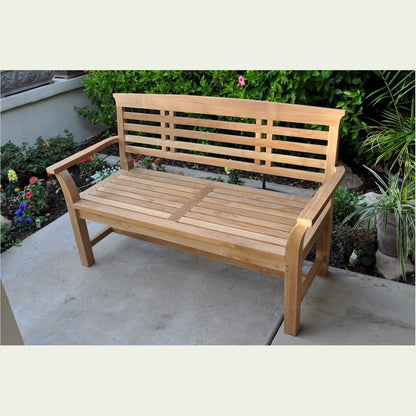 Wooden bench in a garden setting with flowers and plants around
