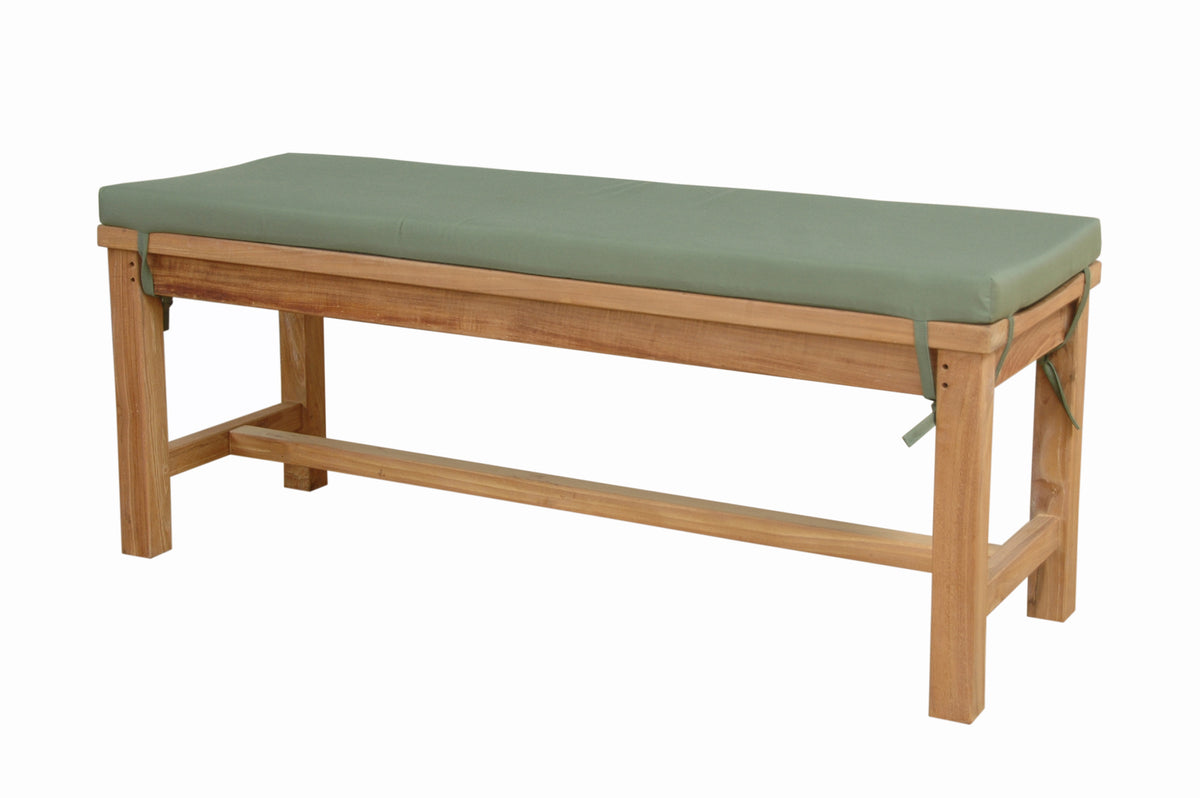 Wooden massage table with a green cushion on a white background