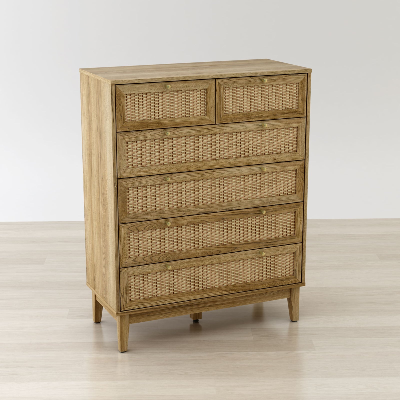Wooden dresser with wicker drawers on a light wooden floor and white wall background
