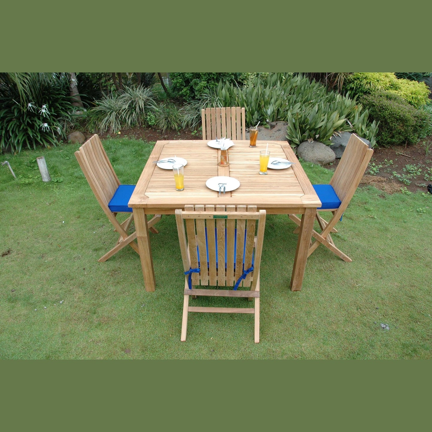 Wooden outdoor dining set with chairs and table on grass