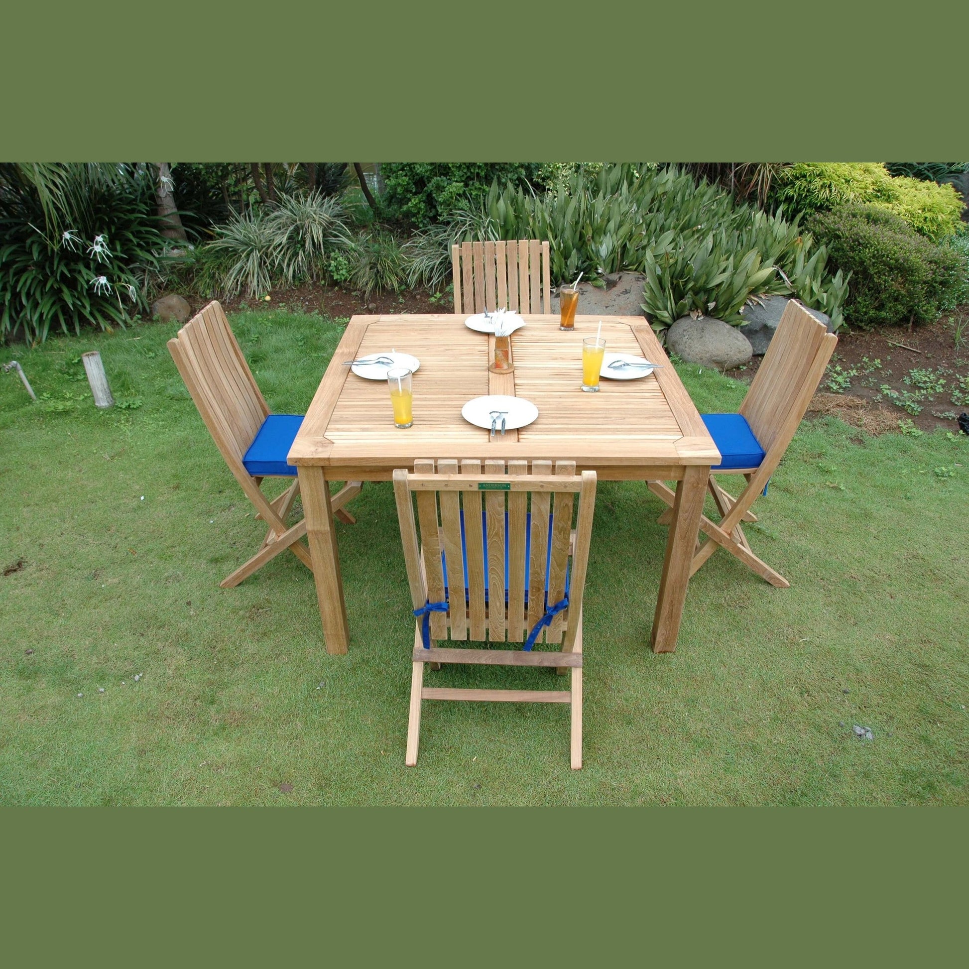 Wooden outdoor dining set with chairs and table on grass