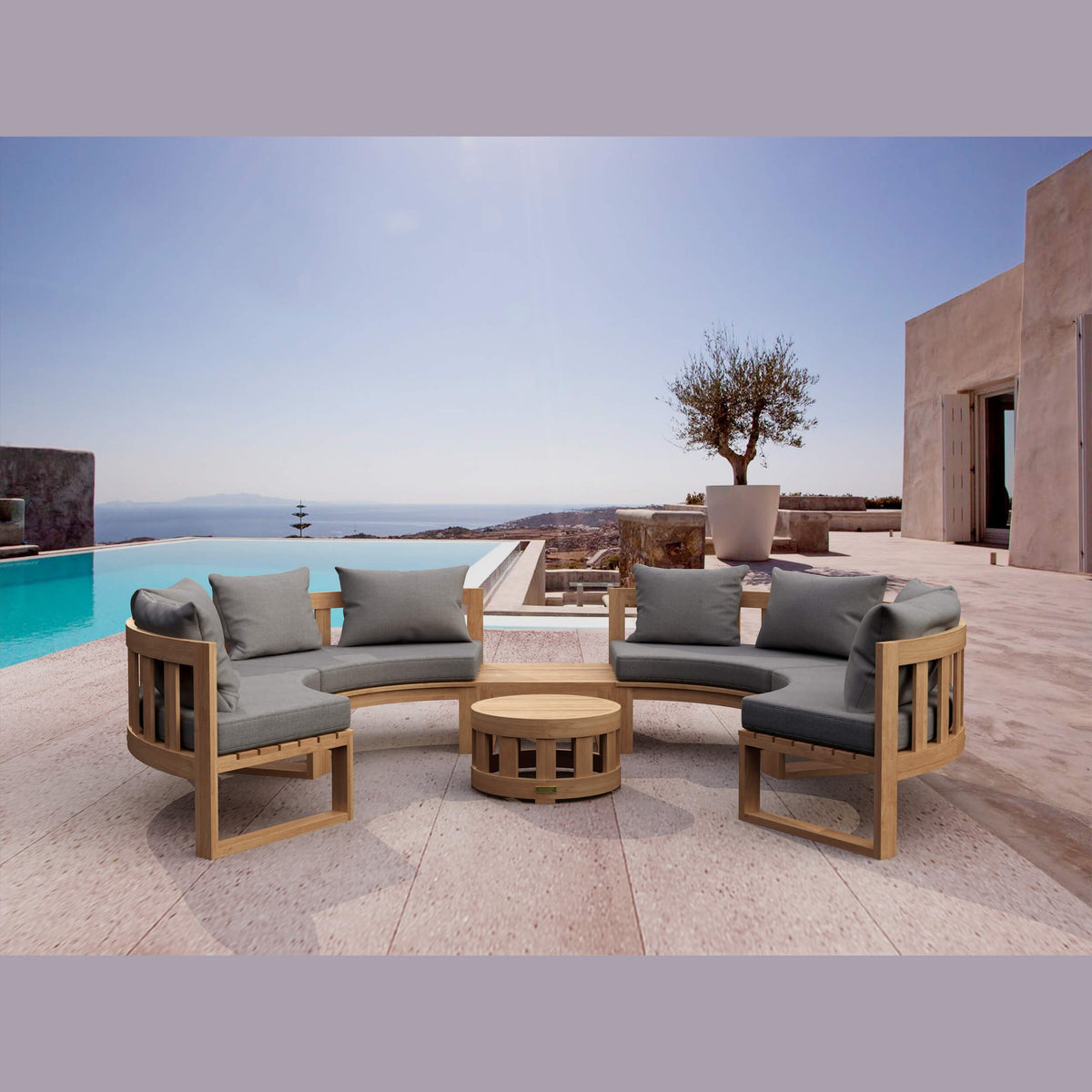 Outdoor patio set with wooden chairs and gray cushions by a pool with ocean view.