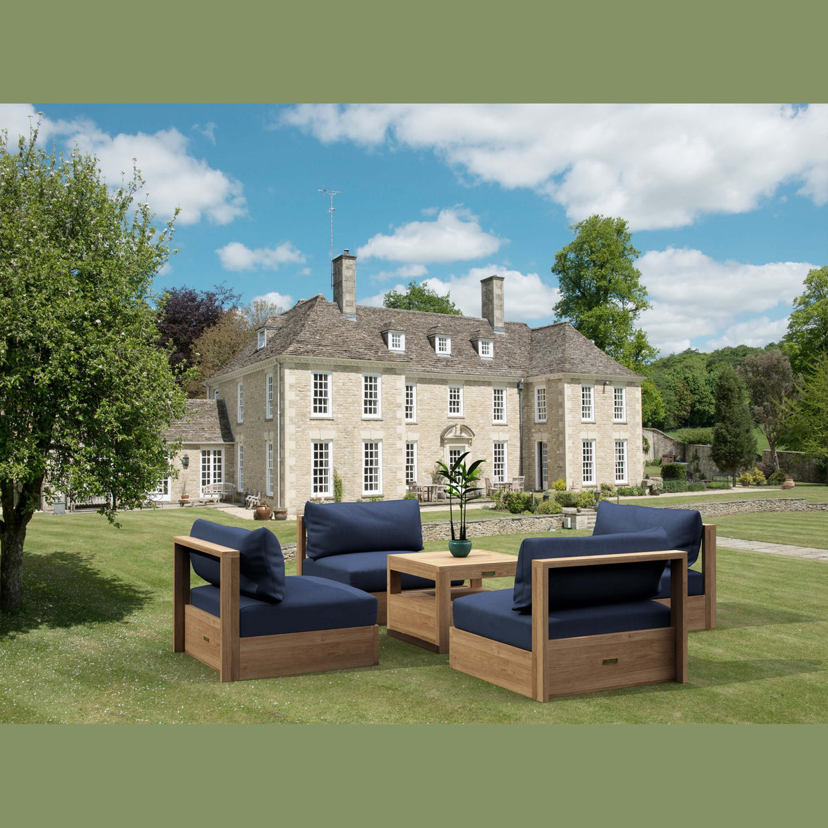 Outdoor furniture set with blue cushions in front of a large house.