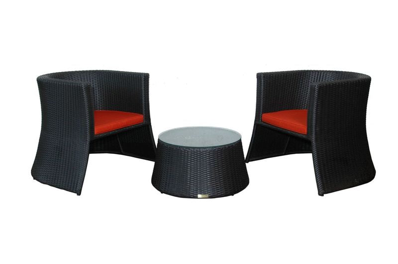 Black wicker chairs with red cushions and a matching round table on a white background