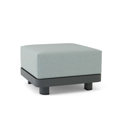 Square ottoman with light gray cushion and black base on a white background