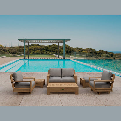 Outdoor patio furniture set with gray cushions by a pool