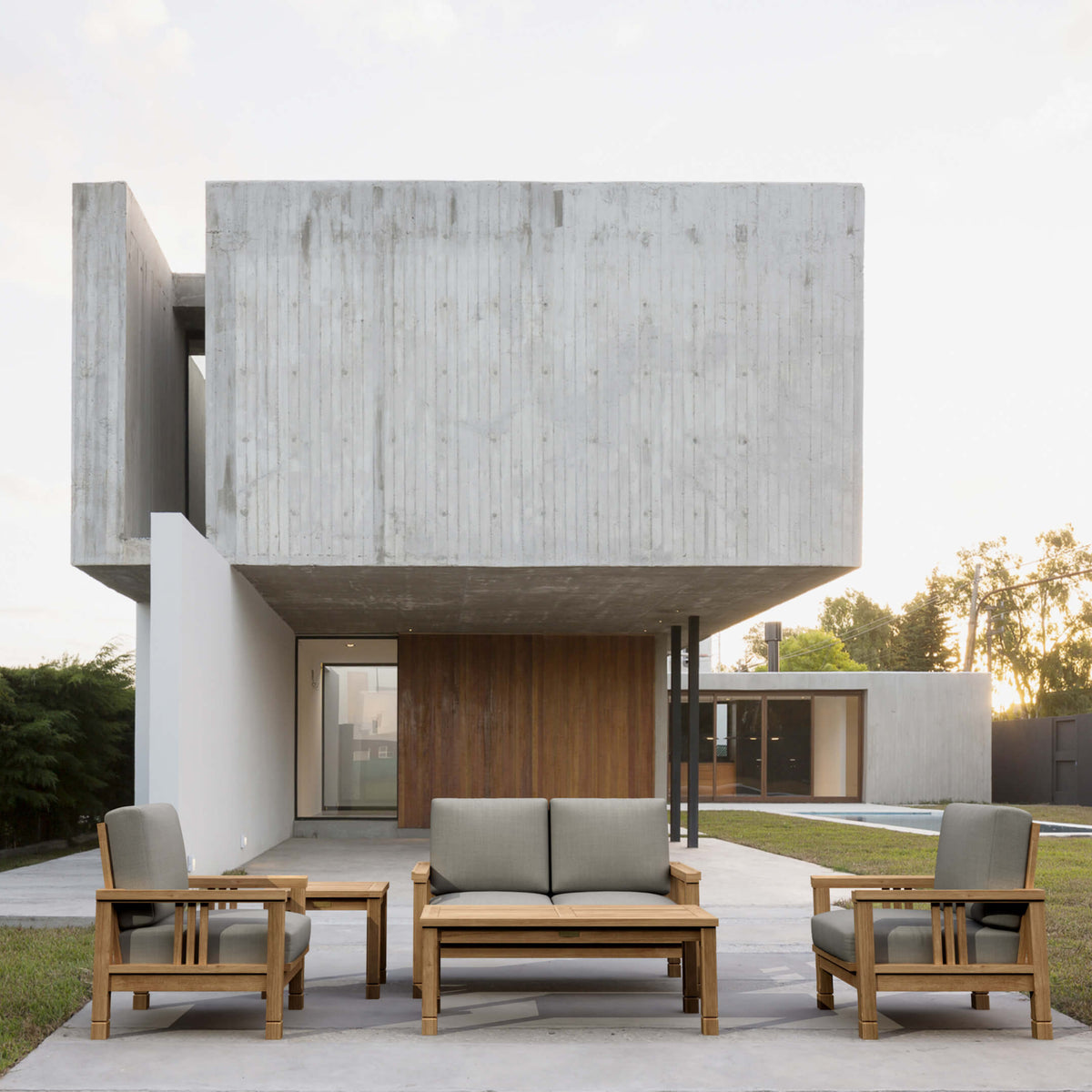 Modern outdoor furniture set in front of a contemporary house.