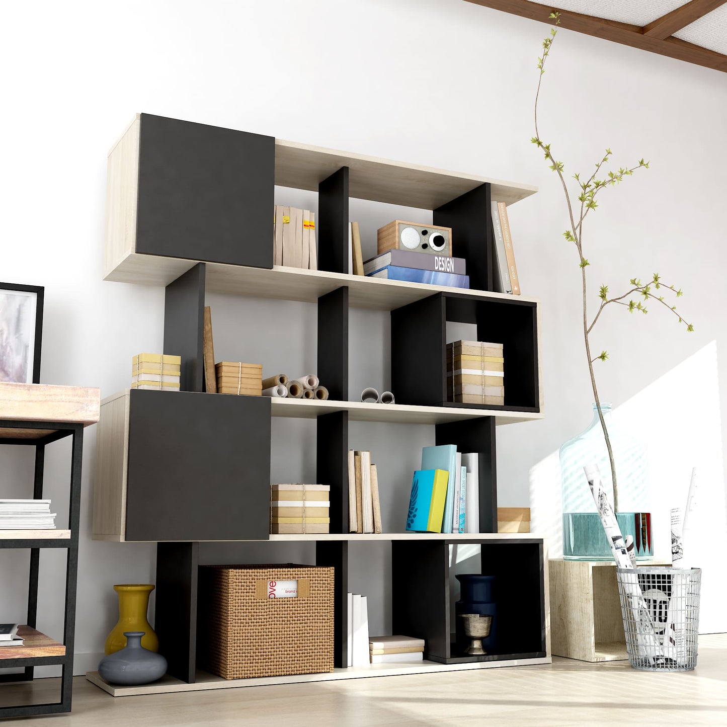 Modern bookshelf with black and white geometric design in a room.
