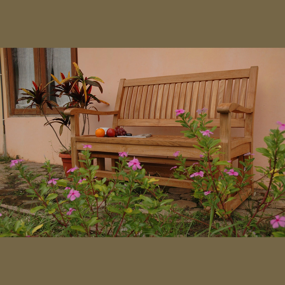 Wooden bench in a garden with flowers and fruits on it