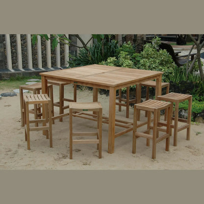 Wooden outdoor dining set with table and stools on sandy ground