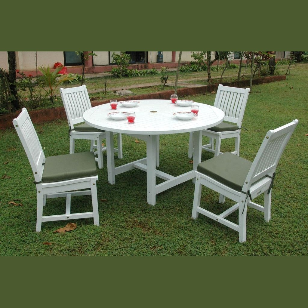 White round table with four matching chairs on a grassy area