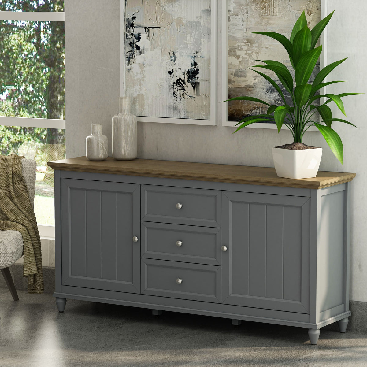 Gray sideboard with wooden top in a room with a plant and abstract art.