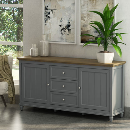 Gray sideboard with wooden top in a room with a plant and abstract art.