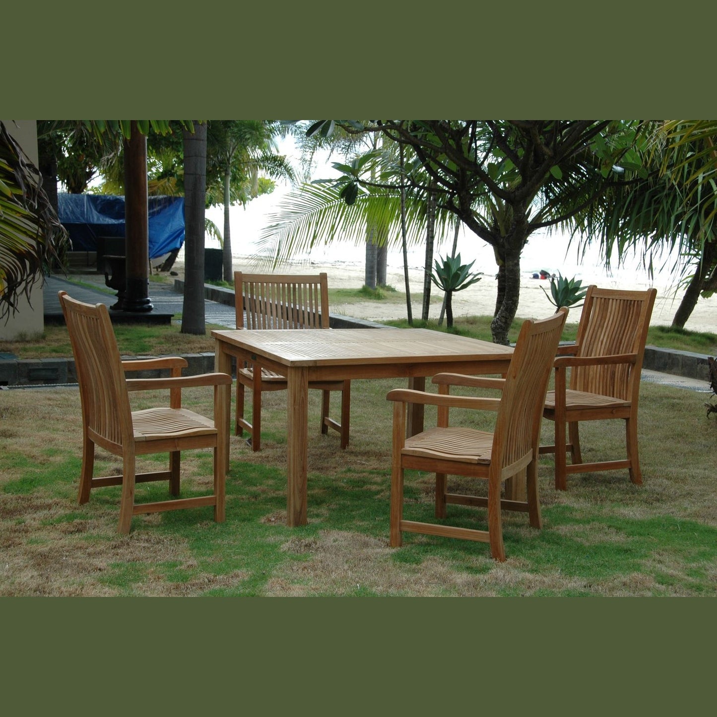 Wooden outdoor dining set with chairs on a grassy area near trees and a body of water.