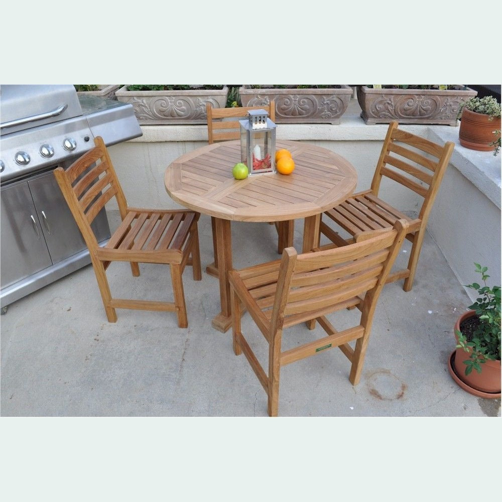 Wooden outdoor table with four chairs on a patio