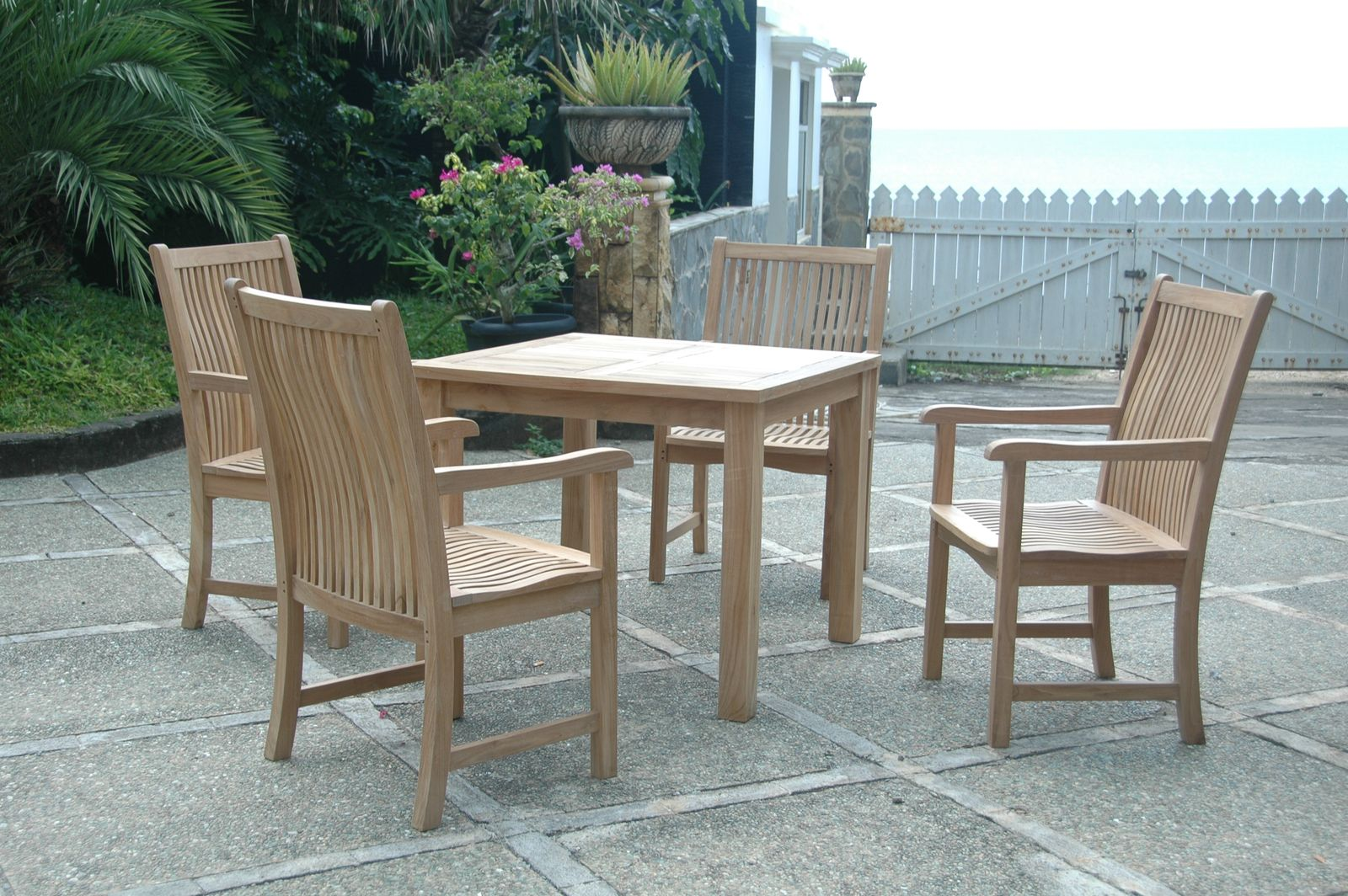 Wooden outdoor dining set with table and chairs on a patio