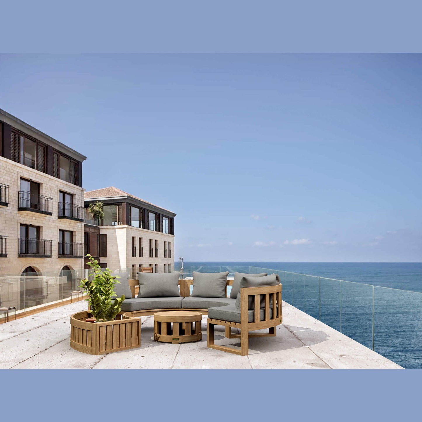 Outdoor furniture set on a balcony with ocean view and cityscape in the background