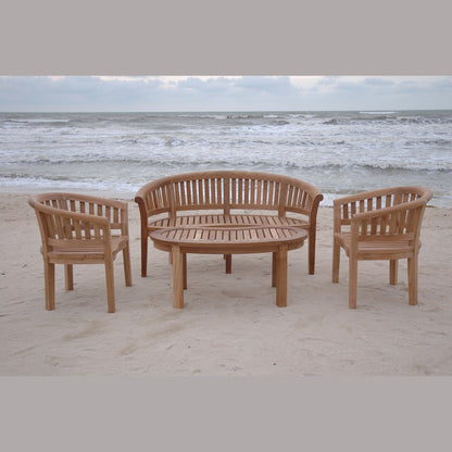Wooden outdoor furniture set on a sandy beach with ocean waves in the background