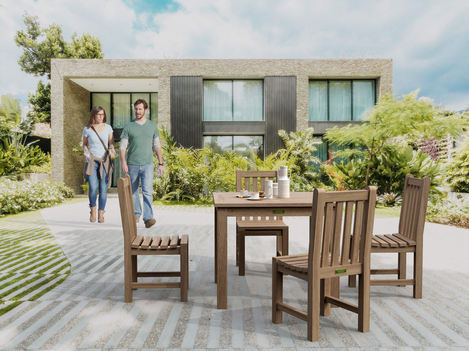 Wooden outdoor dining set with people walking towards a modern house.