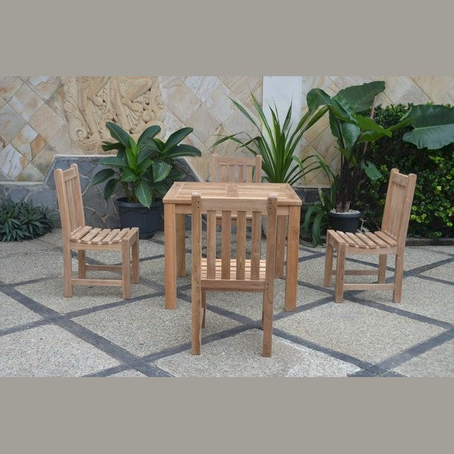 Wooden outdoor table and chairs set with plants in the background