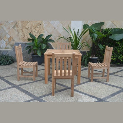 Wooden outdoor table and chairs set with plants in the background