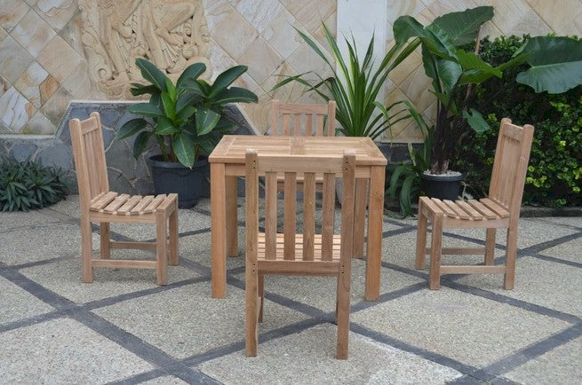 Wooden outdoor table and chairs set with plants in the background