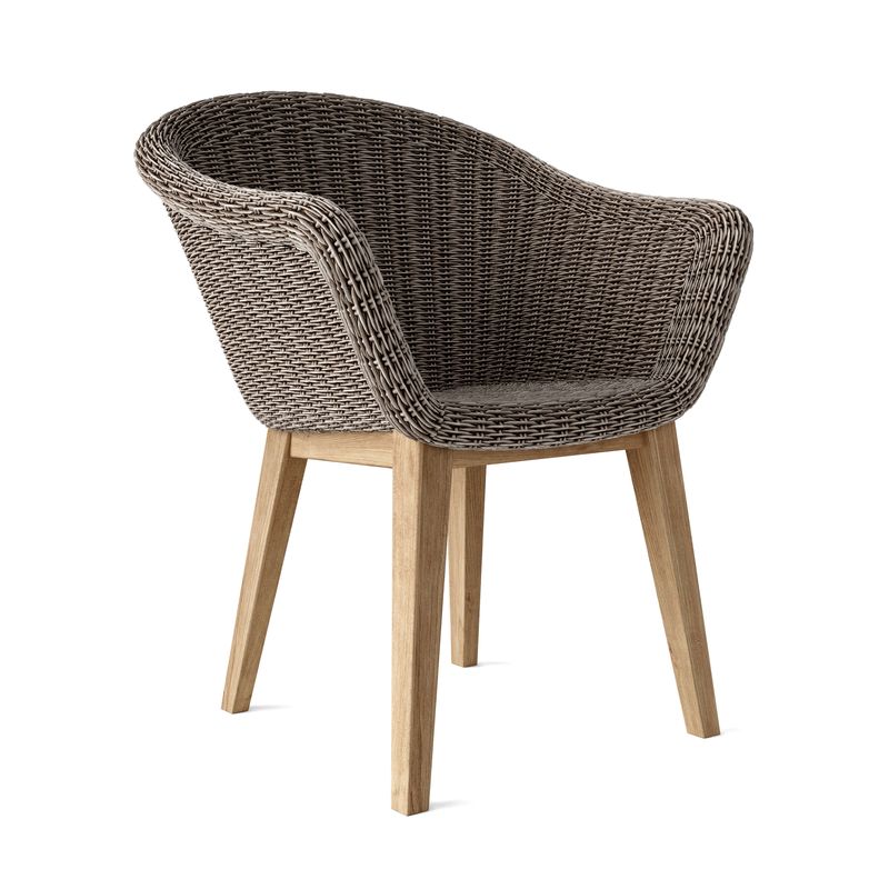 Wicker chair with wooden legs on a white background