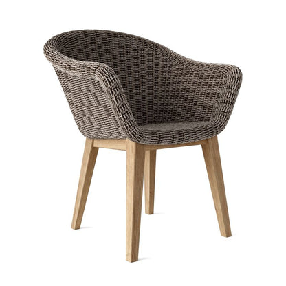 Wicker chair with wooden legs on a white background