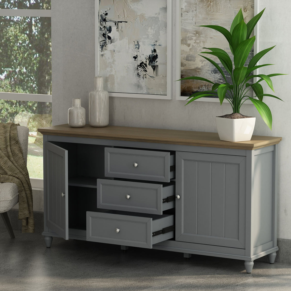 Gray sideboard with wooden top in a room with a plant and abstract art.