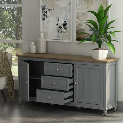 Gray sideboard with wooden top in a room with a plant and abstract art.