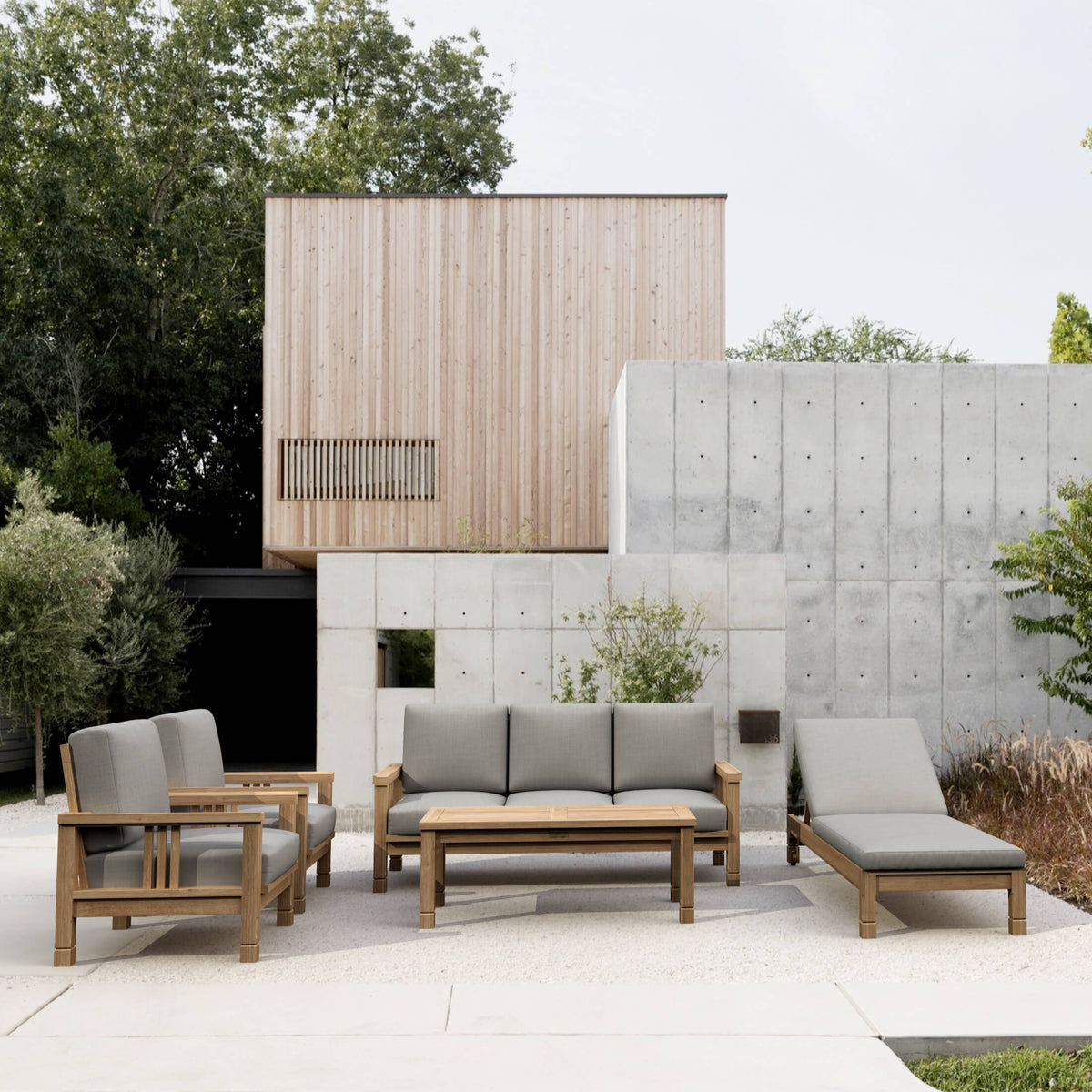 Outdoor patio set with gray cushions in a modern garden setting.