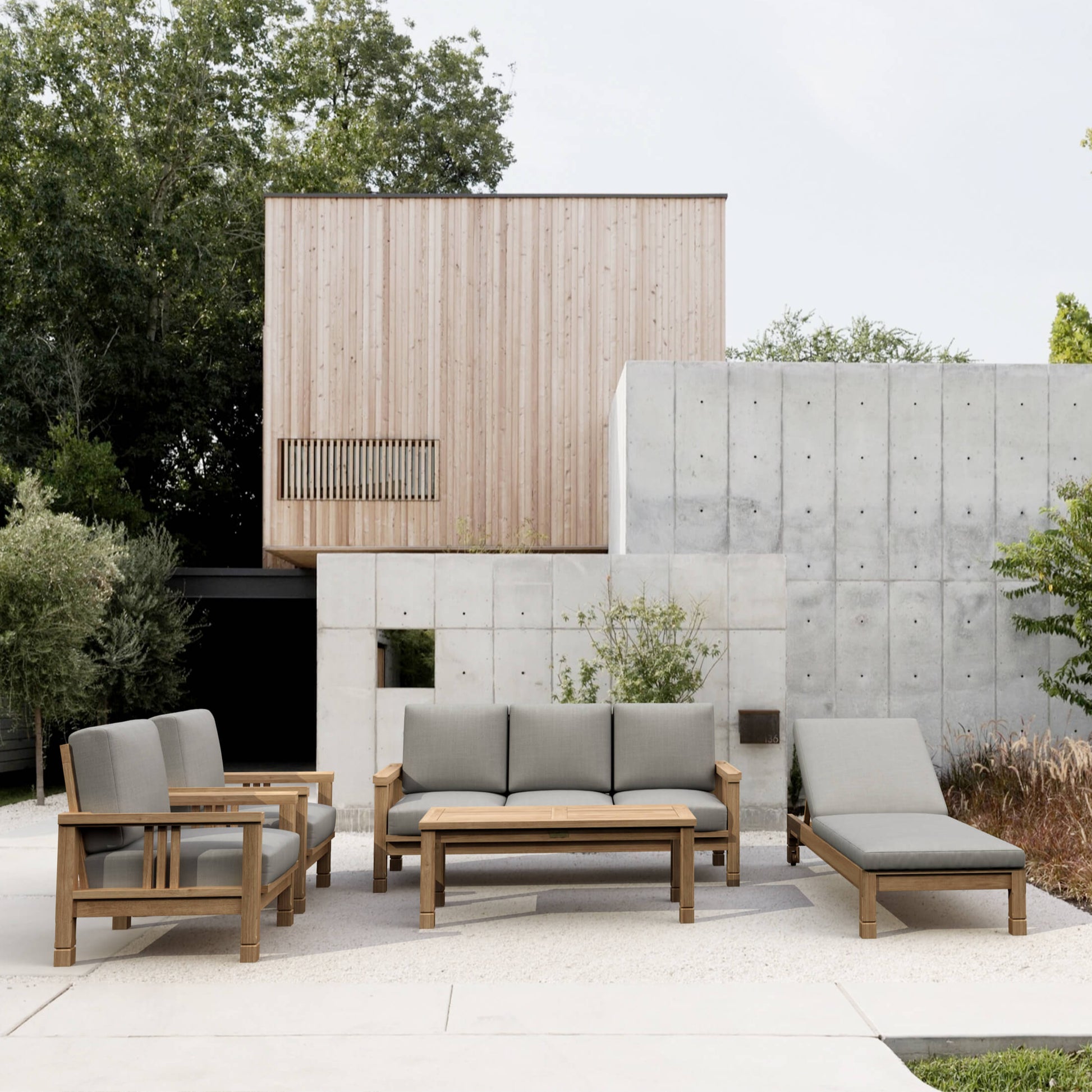 Outdoor patio set with gray cushions in a modern garden setting.