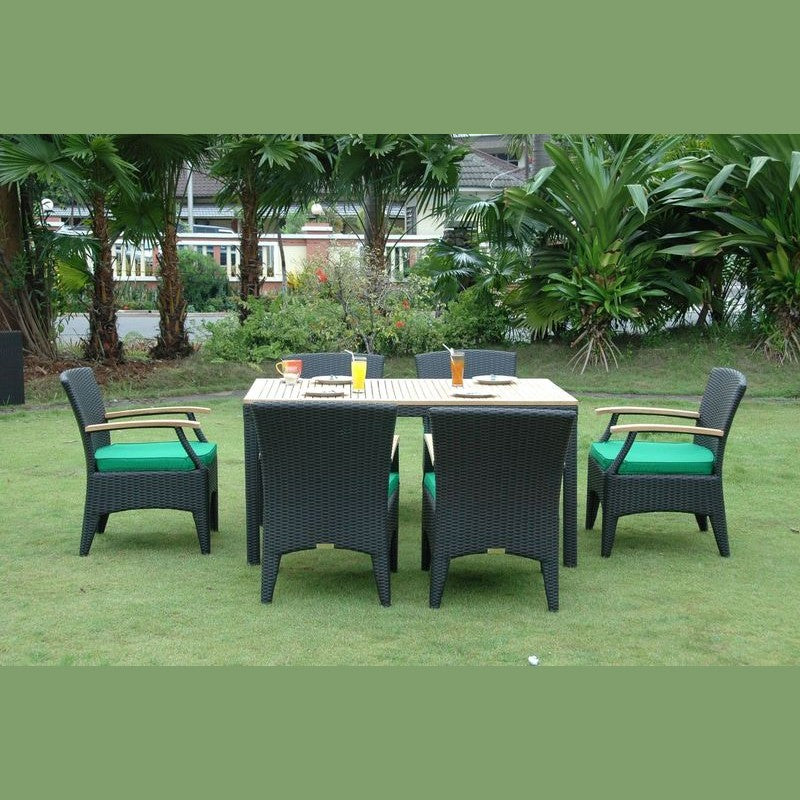 Outdoor furniture set with a table and chairs on a grassy area with trees in the background